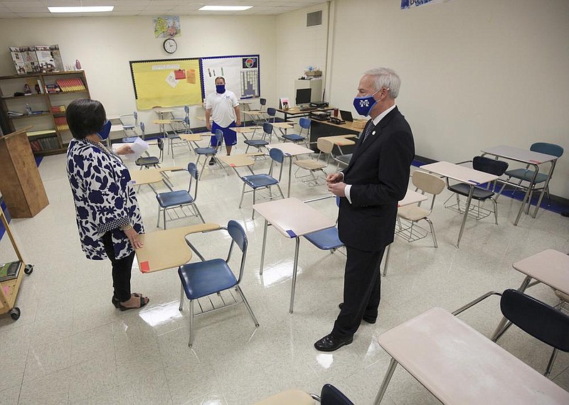 Gov. Asa Hutchinson talks with health teacher Scott Johnson (background) and Principal Susan White as he tours Monticello High School on Wednesday after his daily coronavirus briefing. More photos at arkansasonline.com/813governor/.
(Arkansas Democrat-Gazette/Staton Breidenthal)