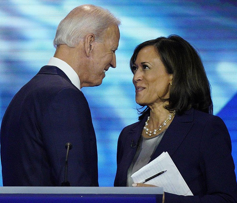 Vice President Joe Biden and then-candidate U.S. Sen. Kamala Har- ris shake hands after a Democratic presidential primary debate on Sept. 12. Though her attacks on Biden during the campaign reportedly stung, the two have since returned to a warm relationship, aides say. (AP/David J. Phillip) 