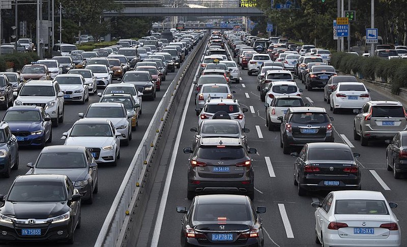 Cars fill a highway in Beijing in July. China’s auto sales rose by 16.4% last month over a year earlier, an industry group said Tuesday. (AP/Ng Han Guan) 
