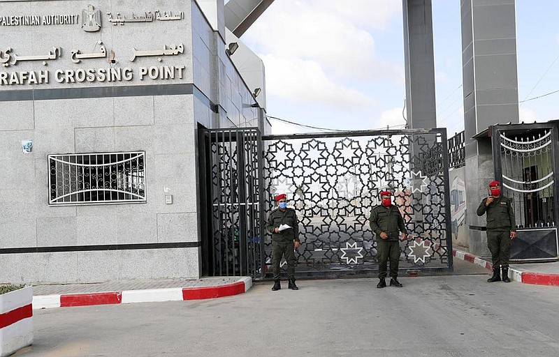 Hamas security officers stand guard Tuesday at the border to the Egyptian side of the Gaza Strip’s Rafah crossing. (AP/Adel Hana) 