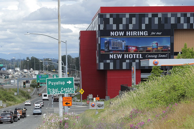 FILE - In this July 9, 2020, file photo, a large video display reads "Now hiring for our new hotel coming soon!," at the new Emerald Queen Casino, which is open, and owned by the Puyallup Tribe of Indians, in Tacoma, Wash.