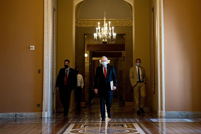 Senate Majority Leader Mitch McConnell walks to the Senate chamber Wednesday. McConnell delayed the planned August recess in hopes of getting a coronavirus relief bill to a vote, but few senators are at the Capitol, the House is not in session and negotiations at an impasse.
(The New York Times/Anna Moneymaker)