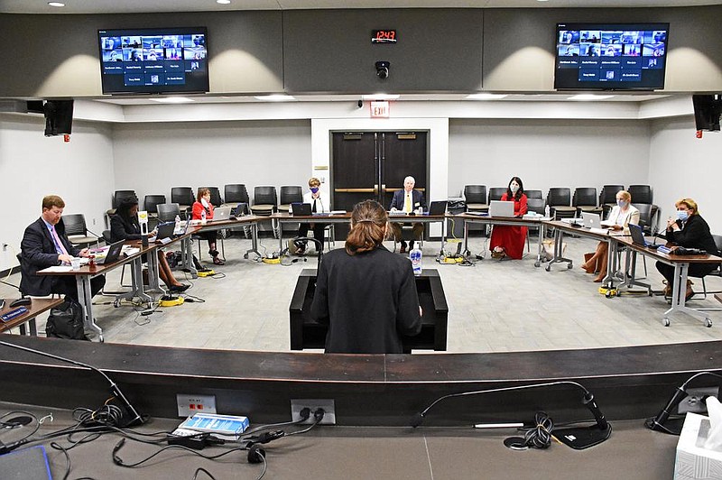 Lori Freno (foreground), general counsel for the state Education Department, speaks during the Board of Education meeting Thursday in Little Rock. Education Secretary Johnny Key (left), facing questions from board members concerned about school safety and planning, contended that “we’ve learned a lot since the spring” and “know better” how to manage.
(Arkansas Democrat-Gazette/Staci Vandagriff)