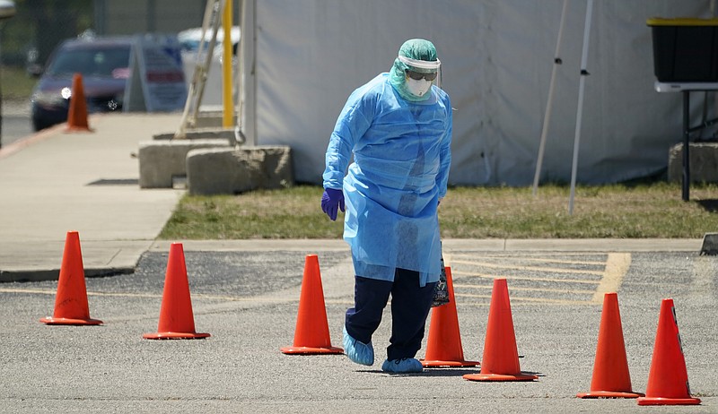 Medical personnel prepare a drive-thru COVID-19 testing site, Friday, Aug. 14, 2020, in San Antonio. Coronavirus testing in Texas has dropped significantly, mirroring nationwide trends, just as schools reopen and football teams charge ahead with plans to play. (AP Photo/Eric Gay)
