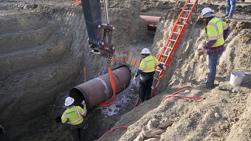 TC Energy workers install a section of the Keystone XL crude oil pipeline in April at the U.S.-Canada border north of Glasgow, Mont., in this file photo provided by the company. TC Energy has submitted an order to Welspun Tubular LLC for the production of more than 1 million feet of 36-inch line pipe for the Keystone project.
(AP)