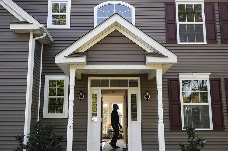 A new owner tours his home in Washingtonville, N.Y., in July. The average home price in the U.S. in May was up 4.2% compared with a year ago, data shows.
(AP)