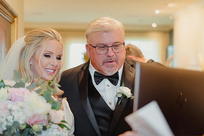 Tara Harper and Fritz Rahr speak to friends via video chat at their July 11 wedding in Fort Worth. Harper knew Rahr was the one after he volunteered to join her on a trip to rescue a German shepherd and then gave it a bath.
(The New York Times/Zerb Mellish)