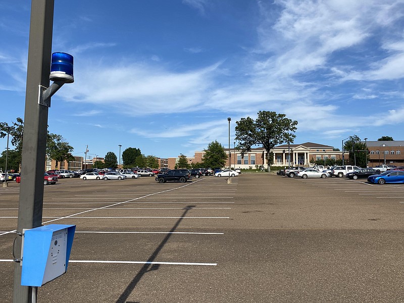 An emergency telephone is located in the center of the Donald W. Reynolds Campus and Community Center parking lot where SAU senior engineering physics major Joshua Keshun Smith was killed in a shooting that left one other student injured. The Childs building, which hosts the University Police Department, can be seen from the parking lot.