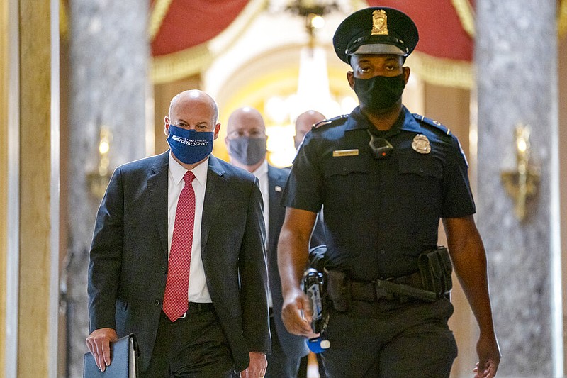 FILE - In this Aug. 5, 2020, file photo Postmaster General Louis DeJoy, left, is escorted to House Speaker Nancy Pelosi's office on Capitol Hill in Washington.