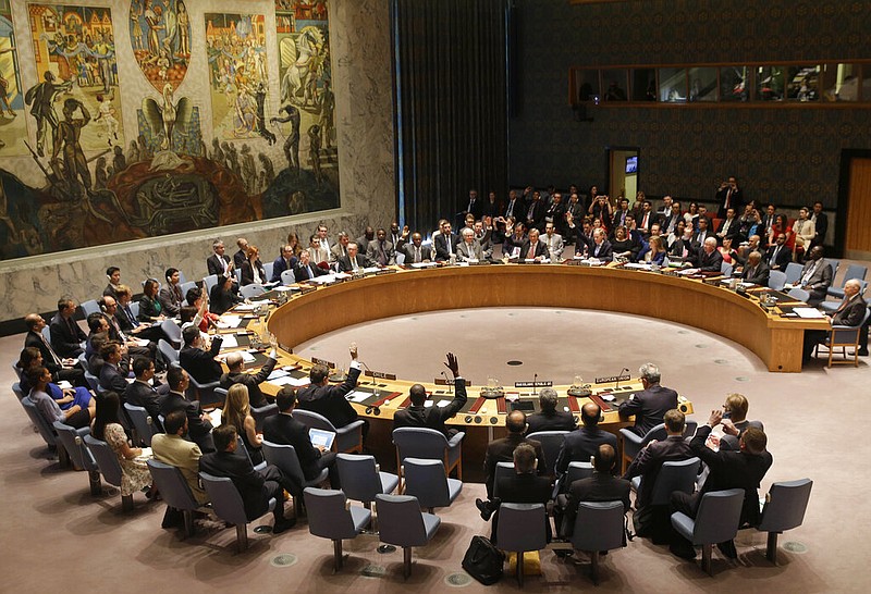 Members of the Security Council vote at United Nations headquarters on the landmark nuclear deal among Iran and six world powers in this July 20, 2015, file photo. President Donald Trump announced Wednesday, Aug. 19, 2020, that the U.S. will demand that the U.N. restore all its sanctions against Iran.