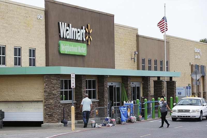 People walk into a Walmart Neighborhood Market store in Oklahoma City earlier this month. (AP) 
