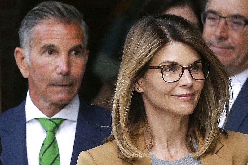 Actress Lori Loughlin and husband, clothing designer Mossimo Giannulli, depart federal court in Boston in this April 3, 2019, file photo. The two were facing charges in a nationwide college admissions bribery scandal.