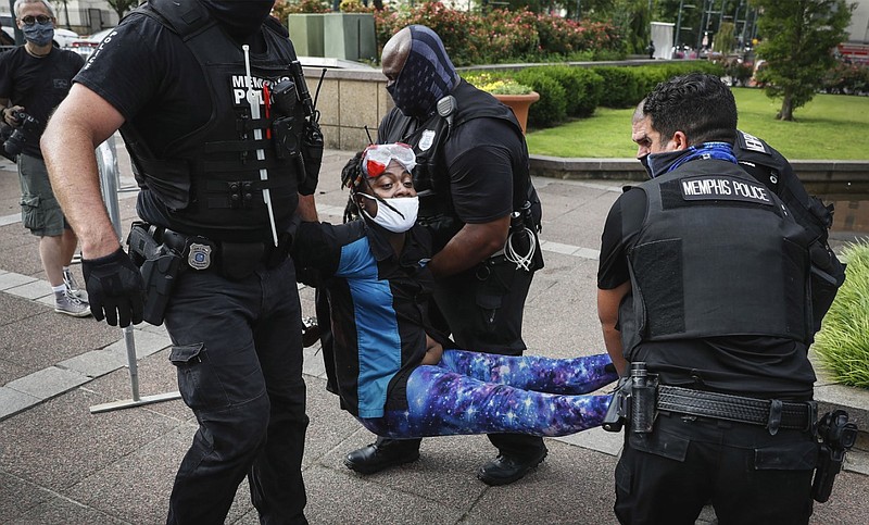 Police arrest an activist who goes by the name "Salamander" outside Memphis City Hall in this July 1, 2020, file photo. Multiple protesters had been camping out in front of City Hall for weeks to demand changes in the city police.