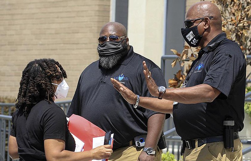 Little Rock School District security personnel stop activist Anika Whitfield as she tries to enter the district’s administration building Thursday in downtown Little Rock during a protest about plans for the reopening of schools.
(Arkansas Democrat-Gazette/Staton Breidenthal)