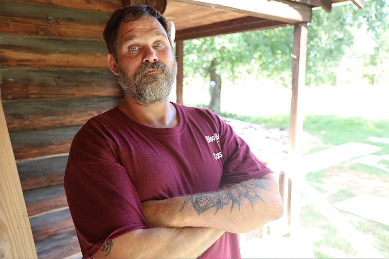 Chet Waters stands outside a cabin he is remodeling. With help from Little Rock-based Restore Hope, he is buiding a new life and career after years of addiction.
(Special to the Democrat-Gazette/Dwain Hebda)