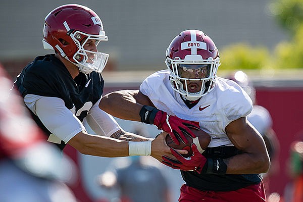 Arkansas running back Rakeem Boyd (5) takes a handoff from quarterback Feleipe Franks during practice Friday, Aug. 21, 2020, in Fayetteville.