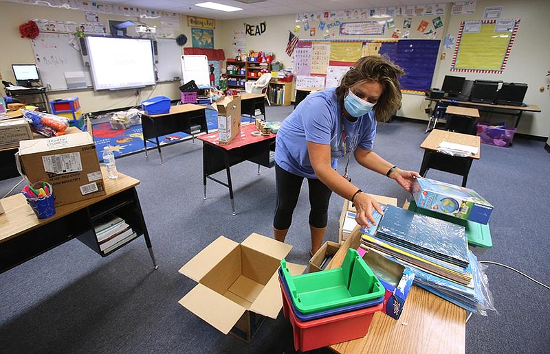 Second-grade teacher Stacie Mitchell unloads instructional materials Tuesday at Chicot Elementary School as teachers and support staff in the Little Rock district prepare for at least some in-person teaching.
(Arkansas Democrat-Gazette/Thomas Metthe)