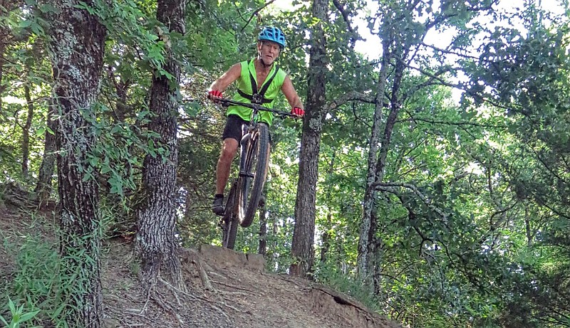 Bob Robinson videotapes himself biking the fast downhill sections of Ben Geren Park's bike trails at Fort Smith in this June 2020 file photo. Robinson, as part of his "covid-19 lockdown project," was making a movie to enter in a contest.