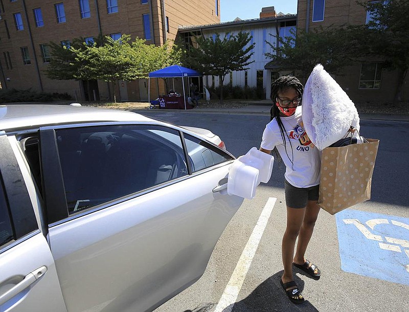 Jayla Greer, 18, from Helena/West Helena unloads items from her car Thursday while moving into her dorm room at the University of Arkansas at Little Rock. (Arkansas Democrat-Gazette/Staton Breidenthal) 
