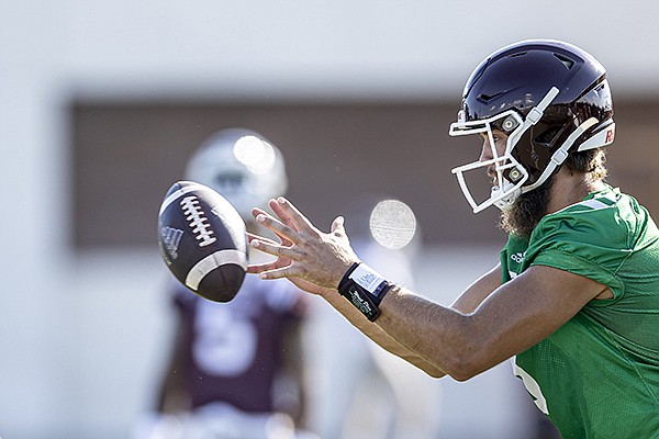 In this Monday, Aug. 18, 2020, photo, Mississippi State quarterback Garrett Shrader takes a snap during an NCAA college football practice in Starkville, Miss. (Austin Perryman/Mississippi State Athletics via AP)


