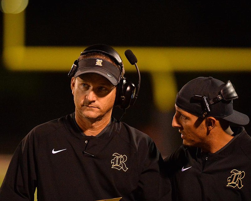 Robinson head coach Todd Eskola talks with an assistant during Friday night's game against Arkadelphia at Senator stadium in Little Rock.

Special to the Democrat-Gazette/JIMMY JONES