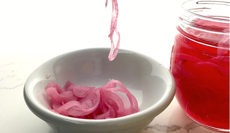Quick pickled red onions take on a pink hue after a couple of days. (Arkansas Democrat-Gazette/Kelly Brant)