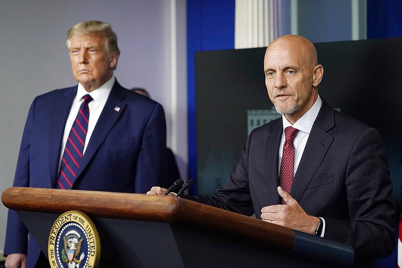 President Donald Trump listens as Dr. Stephen Hahn, commissioner of the U.S. Food and Drug Administration, speaks during a media briefing in the James Brady Briefing Room of the White House, Sunday, Aug. 23, 2020, in Washington.