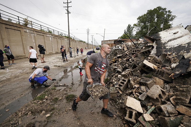 Volunteers clean up department of corrections building Tuesday, Aug. 25, 2020, in Kenosha, Wis.