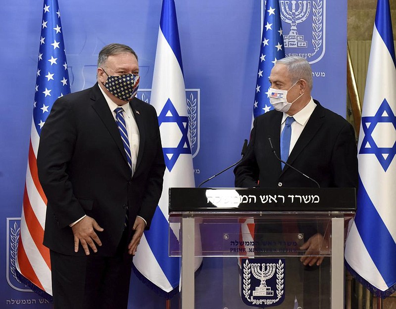 U.S. Secretary of State Mike Pompeo (left) and Israeli Prime Minister Benjamin Netanyahu are shown Mon- day after their joint statement to reporters in Jerusalem. More photos at arkansasonline.com/825pompeo/ (AP/Debbie Hill) 