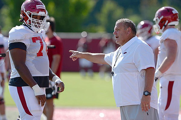 Arkansas coach Sam Pittman directs members of the offensive line Tuesday, Aug. 25, 2020, during practice at the university practice facility in Fayetteville. 