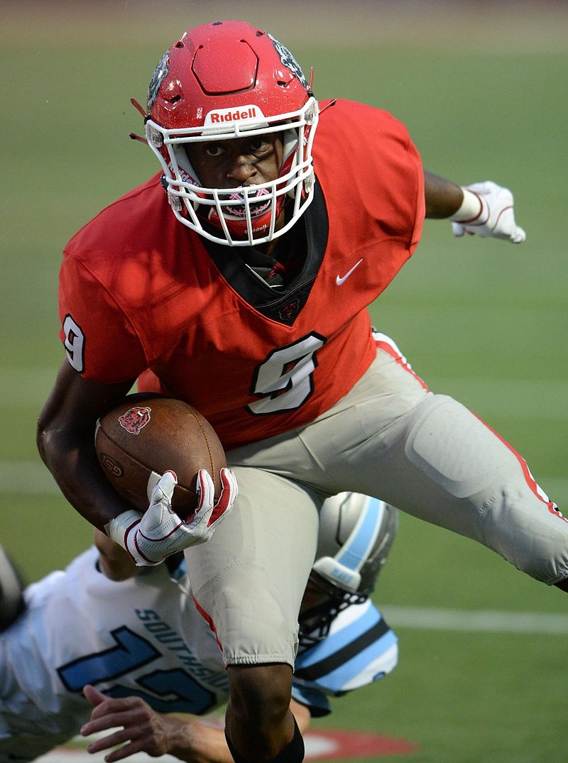 Fort Smith Northside receiver Tyheen Prosise (9) carries the ball after making a catch Thursday, Aug. 27, 2020, as Fort Smith Southside defender Russell Key reaches to make the tackle during the first half of play at Mayo-Thompson Stadium in Fort Smith. Visit nwaonline.com/200828Daily/ for today's photo gallery.
(NWA Democrat-Gazette/Andy Shupe)