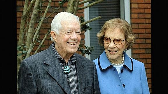 In this image from video, former President Jimmy Carter and former first lady Rosalynn Carter, seen in a photo as they speak on audio only, during the second night of the Democratic National Convention on Tuesday, Aug. 18, 2020. (Democratic National Convention via AP)