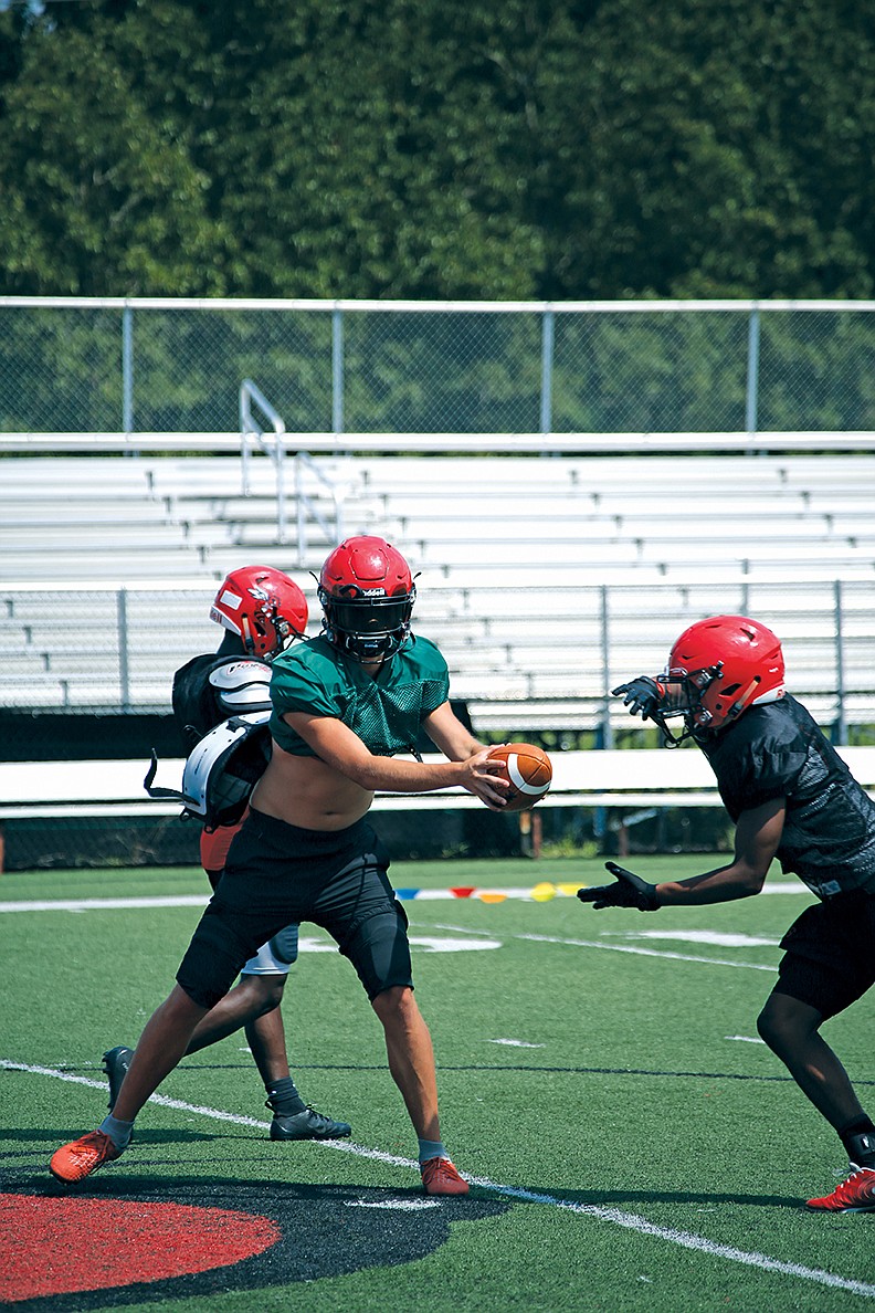 Maumelle senior quarterback Jonathan Reyes hands the ball off to junior Jaylen Waits during a recent practice. The Hornets finished 8-3 a year ago, including a loss to Texarkana in the first round of the state playoffs.