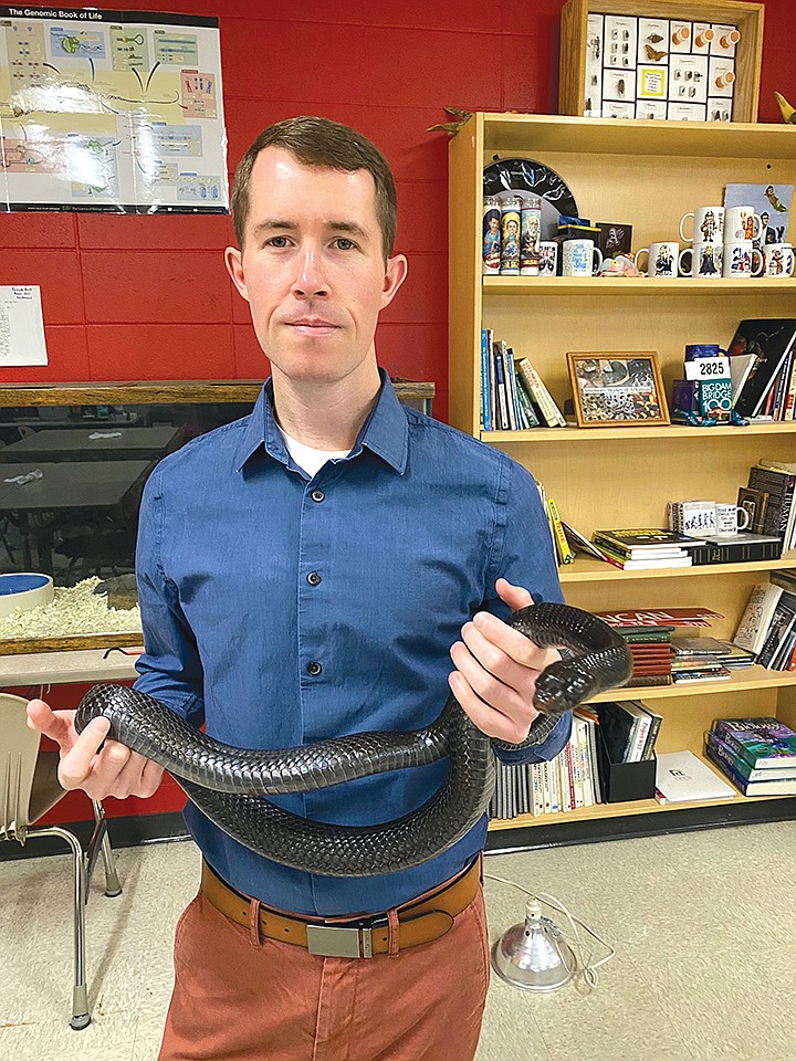 Chance Duncan, a biology teacher at Russellville High School, holds his classroom snake, an eastern indigo snake, which is a federally protected threatened species. They live in the southeast United States and are the largest nonvenomous snakes in the country. Duncan was recently named the 2020 Outstanding Biology Teacher for Arkansas from the National Association of Biology Teachers.