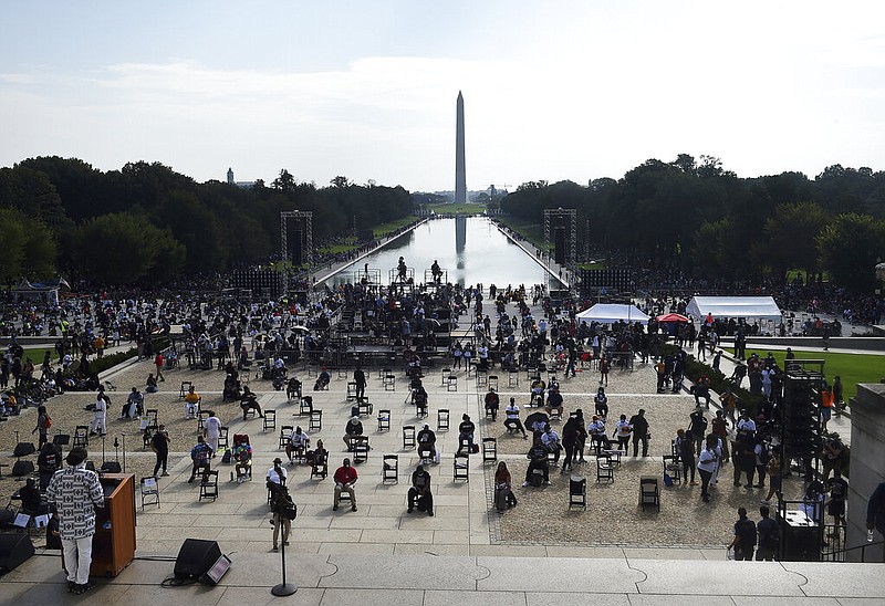 Demonstrators gather at the Lincoln Memorial as final preparations are made for the March on Washington, Friday Aug. 28, 2020, at the Lincoln Memorial in Washington, on the 57th anniversary of the Rev. Martin Luther King Jr.’s “I Have A Dream” speech.