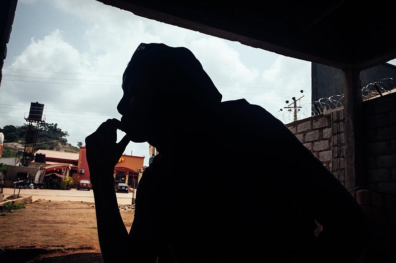 Amina Ahmed, the wife of outspoken atheist Mubarak Bala, gazes through a window in Abuja, Nigeria, on Aug. 9. Bala, head of the Humanist Association of Nigeria, was seized by the police in April and has disappeared in custody.
(The New York Times/KC Nwakalor)