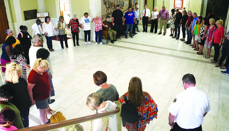 Prayer circle: El Dorado community members hold hands in prayer to start the 40 Days of Prayer in 2019, in the lobby of City Hall. Siandhara Bonnet/News-Times
