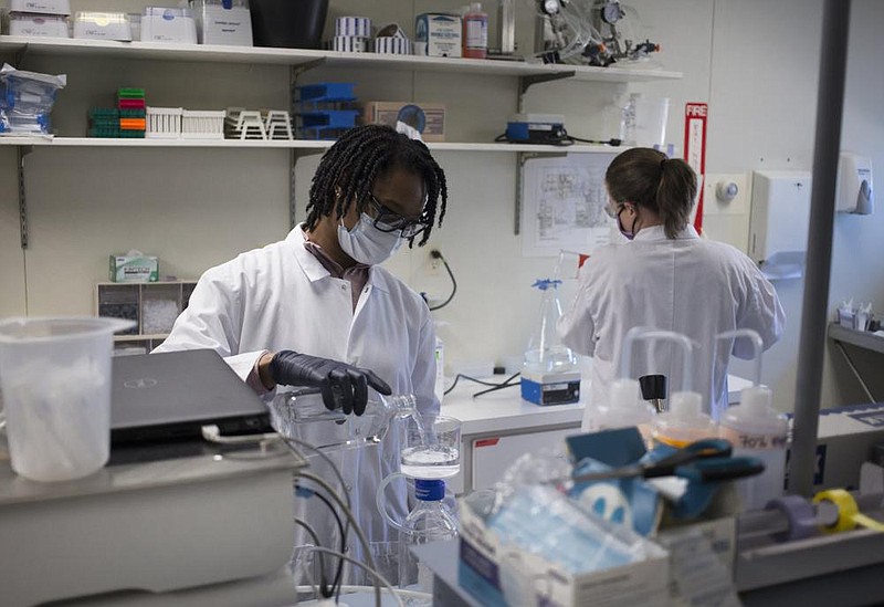 Ashley Willis, senior research and development lab tech (left) and Mckimzie Fruchtl, research and development engineer, work Monday at Pel-Freez in Rogers. After being a family-owned business for decades, Pel-Freez was quietly bought by a capital invest- ment firm this year. (NWA Democrat-Gazette/Charlie Kaijo) 