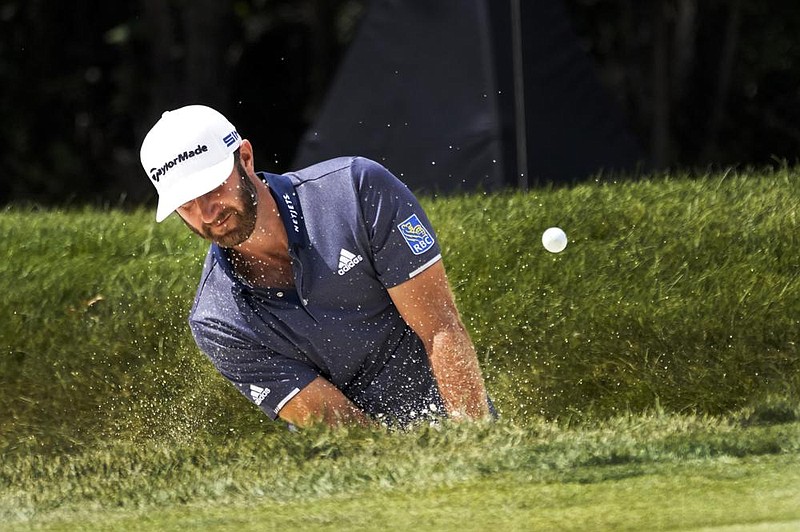 Dustin Johnson hits out of a sand trap on the first hole during the third round of the BMW Championship on Saturday at the Olympia Fields Country Club in Olympia Fields, Ill. Johnson shot a 1-under 69 to share the lead with Hideki Matsuyama.
(AP/Charles Rex Arbogast)