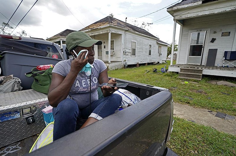 Linda Smoot, who fled from Hurricane Laura in a pickup with eight others last week, reacts Sunday after seeing the damage to her niece’s home in Lake Charles, La. More photos at arkansasonline. com/831laura/. (AP/Gerald Herbert) 