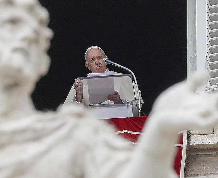Pope Francis recites the Angelus noon prayer Sunday from the window of his studio overlooking St. Peter’s Square at the Vatican. (AP/Andrew Medichini) 
