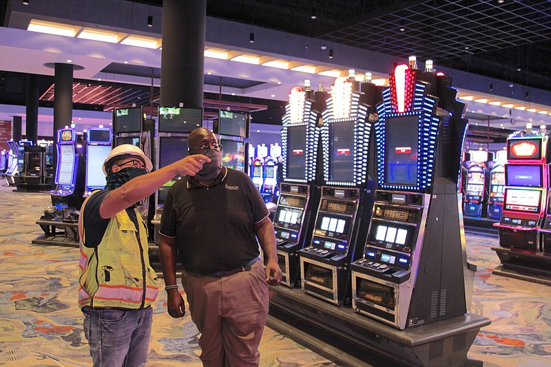 Suffolk Construction Site Supervisor Arturo Vazquez, at left, points out recent progress in the construction of the $350 million Saracen Casino Resort project, to Saracen Casino manager of events and promotions Henri Linton Jr. during a recent walk through of the site. According to Quapaw Chairman Joseph Tali Byrd, the casino will have a soft opening Oct. 1, and will have a grand opening Oct. 20.