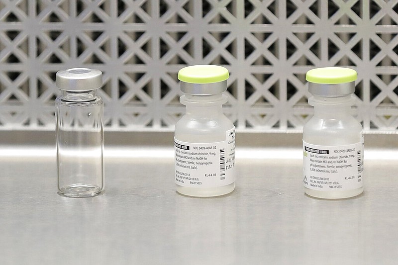 FILE - This March 16, 2020 file photo shows vials used by pharmacists to prepare syringes used on the first day of a first-stage safety study clinical trial of the potential vaccine for covid-19, the disease caused by the new coronavirus, in Seattle.