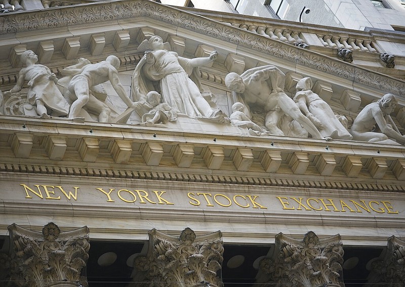 FILE - Marble sculptures occupy the pediment above the New York Stock Exchange signage, Tuesday Aug. 25, 2020, in New York. Stocks are falling again on Wall Street Friday, Sept. 4, a day after a big slump in technology companies pulled the market to its biggest drop since June. (AP Photo/Bebeto Matthews, File)

