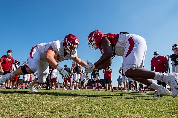 An Arkansas offensive lineman and defensive lineman go head-to-head in a drill during a preseason practice on Aug. 25, 2020.