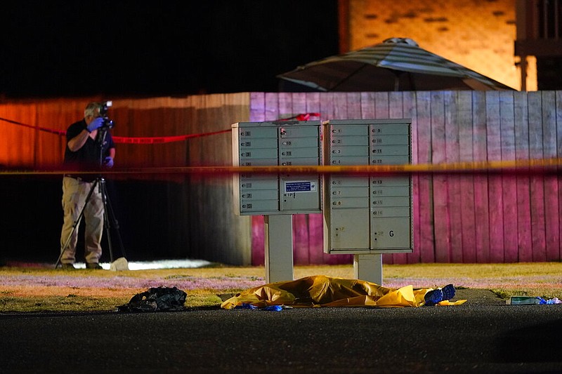 Officials work at a scene late Thursday, Sept. 3, 2020, where a man suspected of fatally shooting a supporter of a right-wing group in Portland, Ore., the week before was killed as investigators moved in to arrest him in Lacey, Wash.