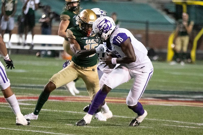 Central Arkansas linebacker Malik Wilson (18) tries to avoid Alabama-Birmingham receiver Trea Shropshire after intercepting a pass during Thursday night’s game in Birmingham, Ala.
(Courtesy of University of Central Arkansas)