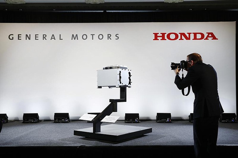 A photographer captures images of the General Motors-Honda Next Generation Fuel Cell after a news conference in Detroit in January. On Thursday, General Motors and Honda said they have signed a deal to explore sharing vehicle underpinnings and propulsion systems in North America.
(AP)