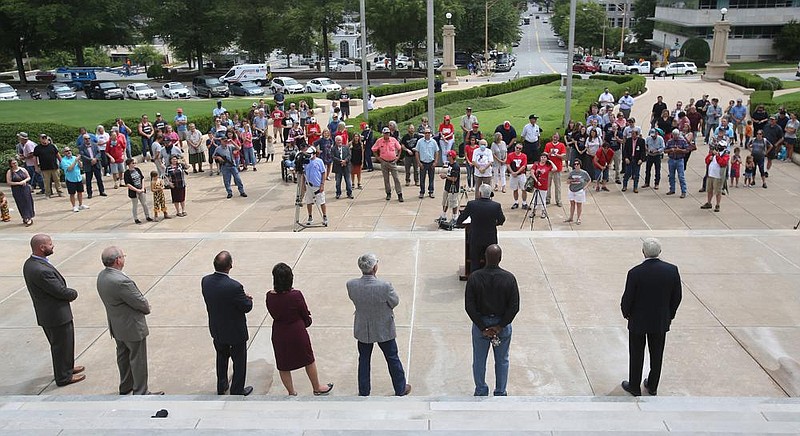 Supporters listen as state Rep. Brandt Smith, R-Jonesboro, speaks Thursday from the steps of the state Capitol during the announcement of a lawsuit aimed at overturning Gov. Asa Hutchinson’s months-long state of emergency and his administration’s public health directives.
(Arkansas Democrat-Gazette/Thomas Metthe)