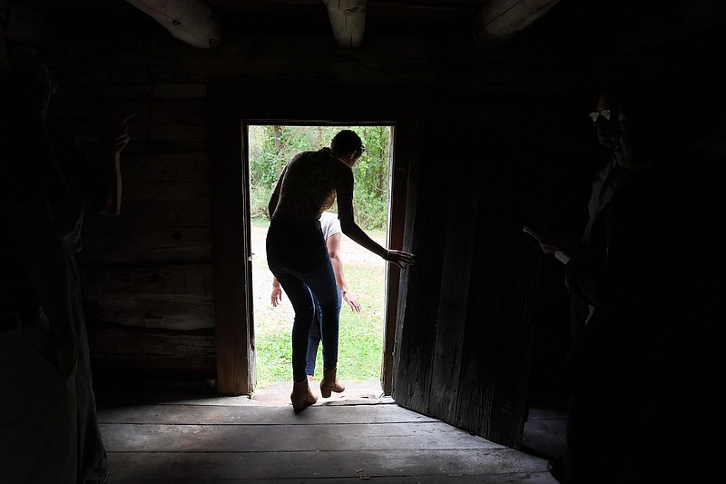 Amina King, 15, ducks as she leaves the log cabin in Gaithersburg, Md., that housed the King family's enslaved ancestors, who were considered the property of Thomas Griffith in the 19th century.
(Washington Post/Katherine Frey)